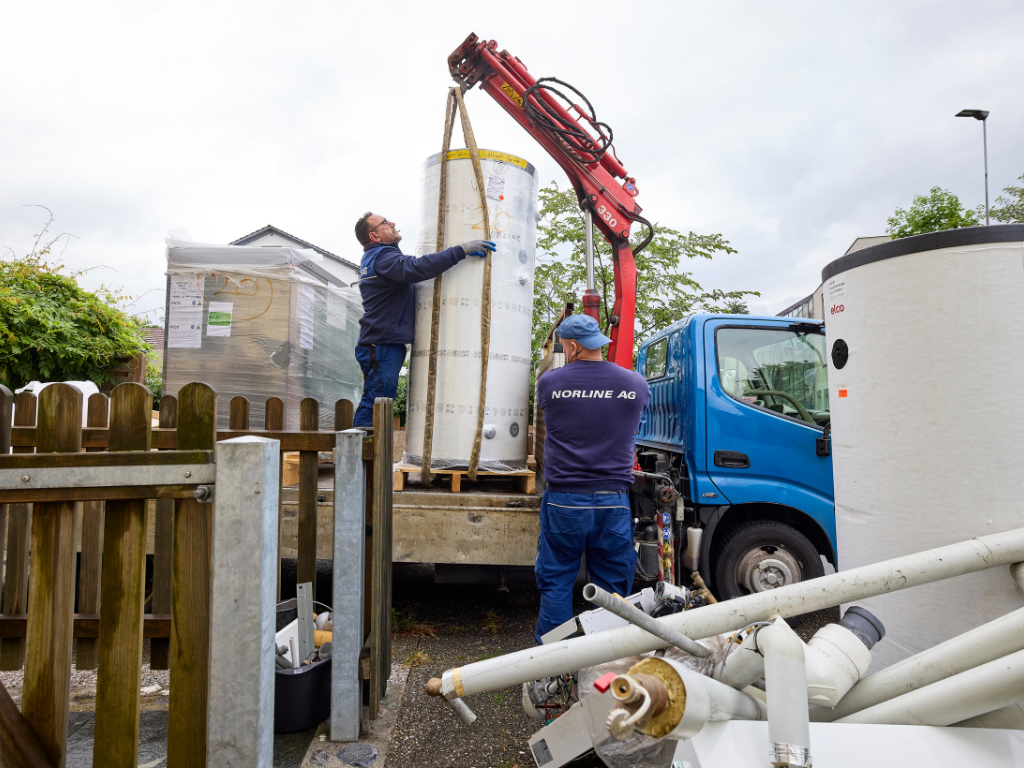 Montage eines Warmwasserspeichers mit Kran bei der Installation einer ELCO Wärmepumpe.